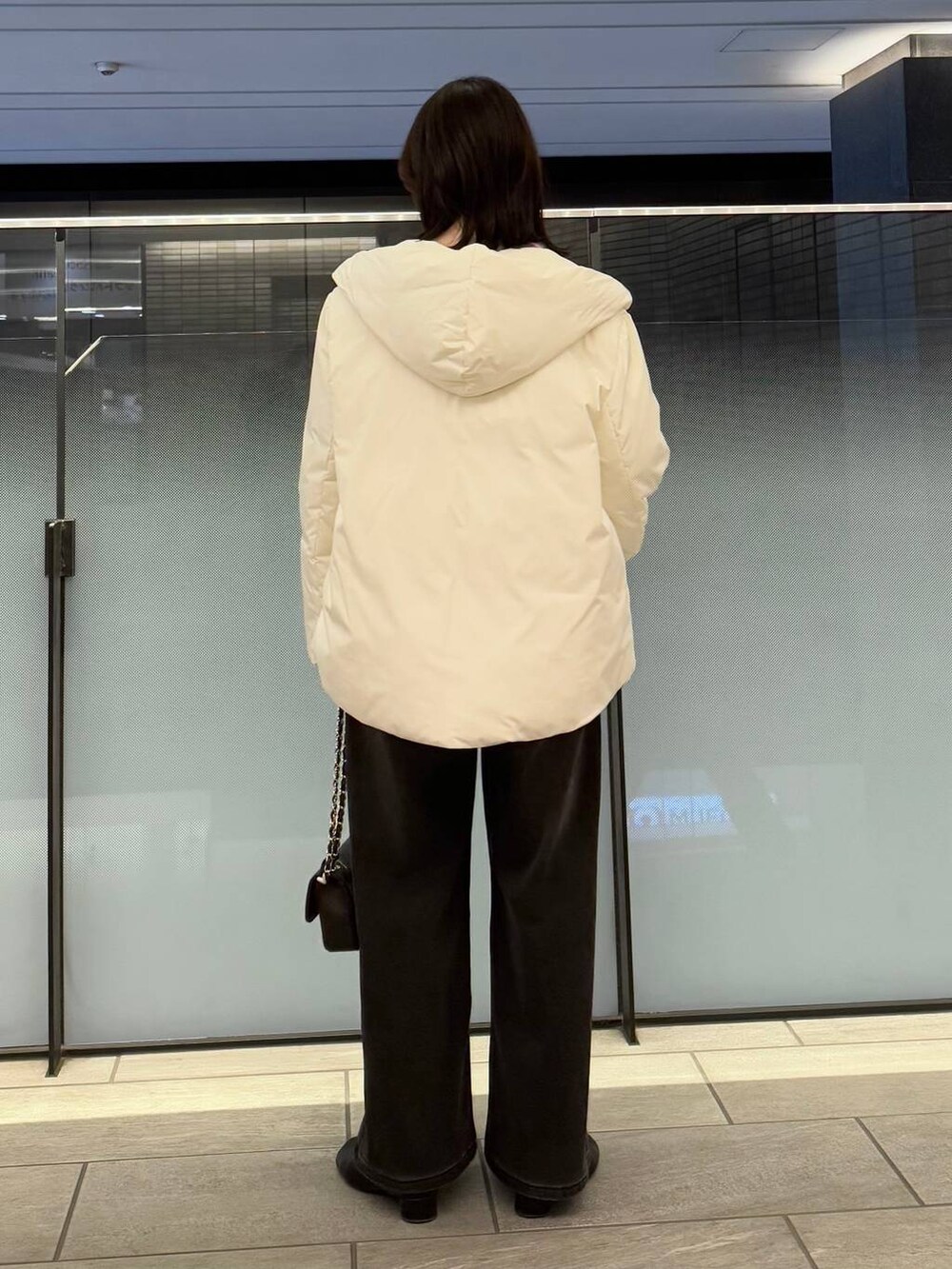 ピンク系のニット/セーター、ブラック系のデニムパンツ、ブラック系のブーツを着用したレディースの冬コーディネートの3枚目の写真