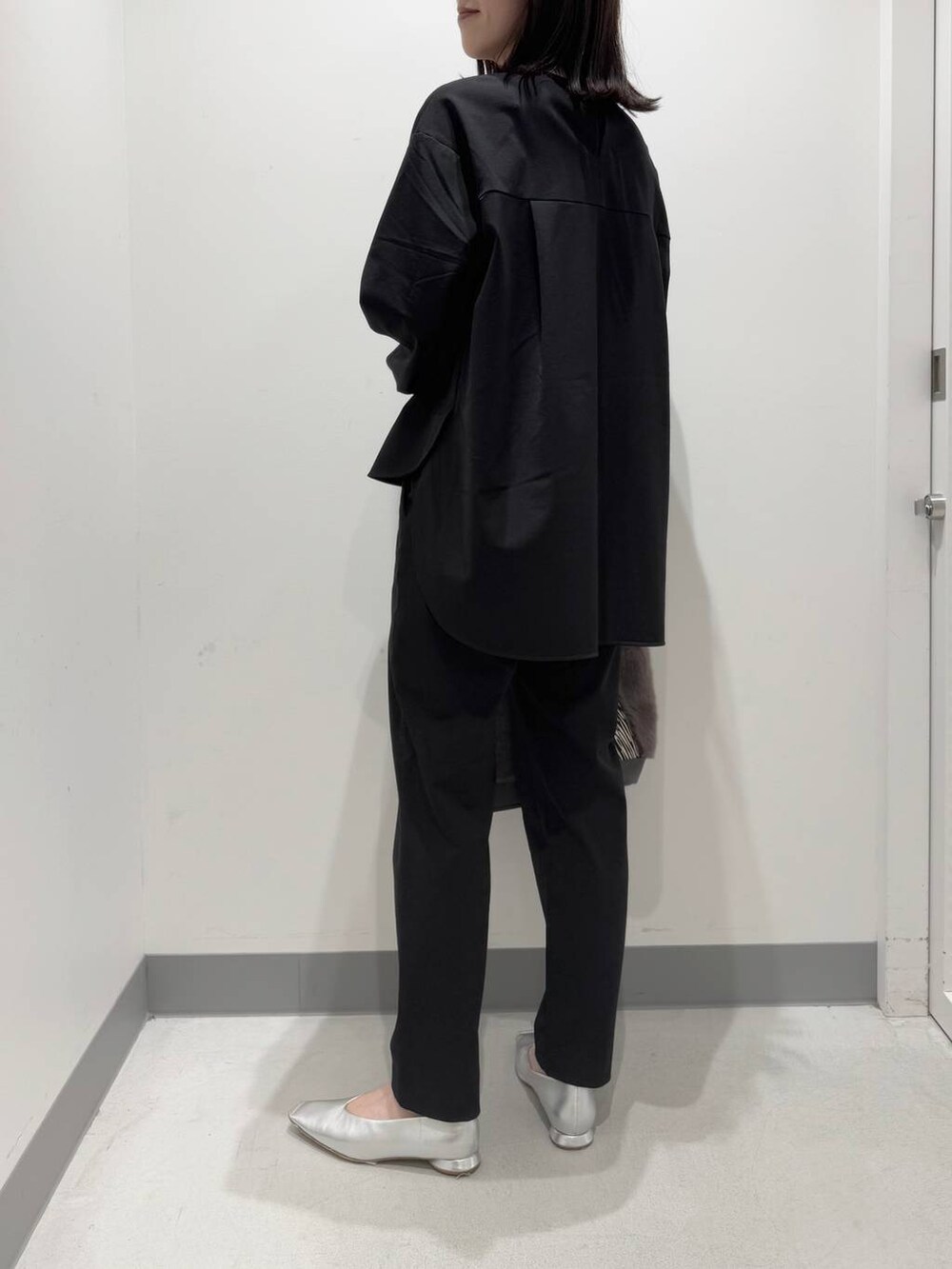 ブラック系のシャツ/ブラウス、ブラック系のその他パンツ、グレー系のトートバッグを着用したレディースの冬コーディネートの3枚目の写真