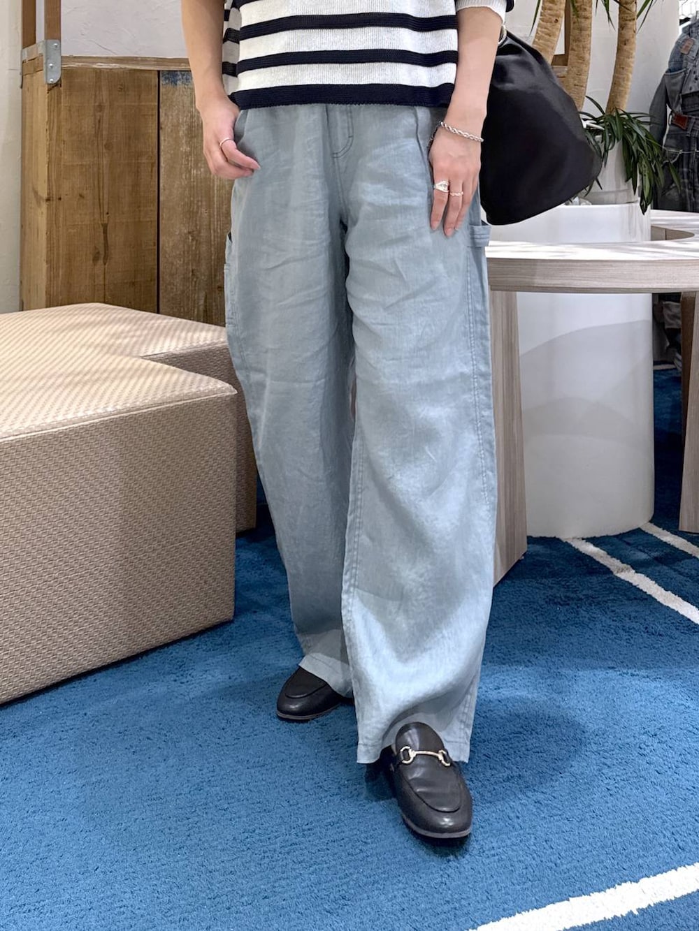 ホワイト系のニット/セーター、グリーン系のその他パンツ、ブラック系のトートバッグを着用したレディースの春コーディネートの5枚目の写真