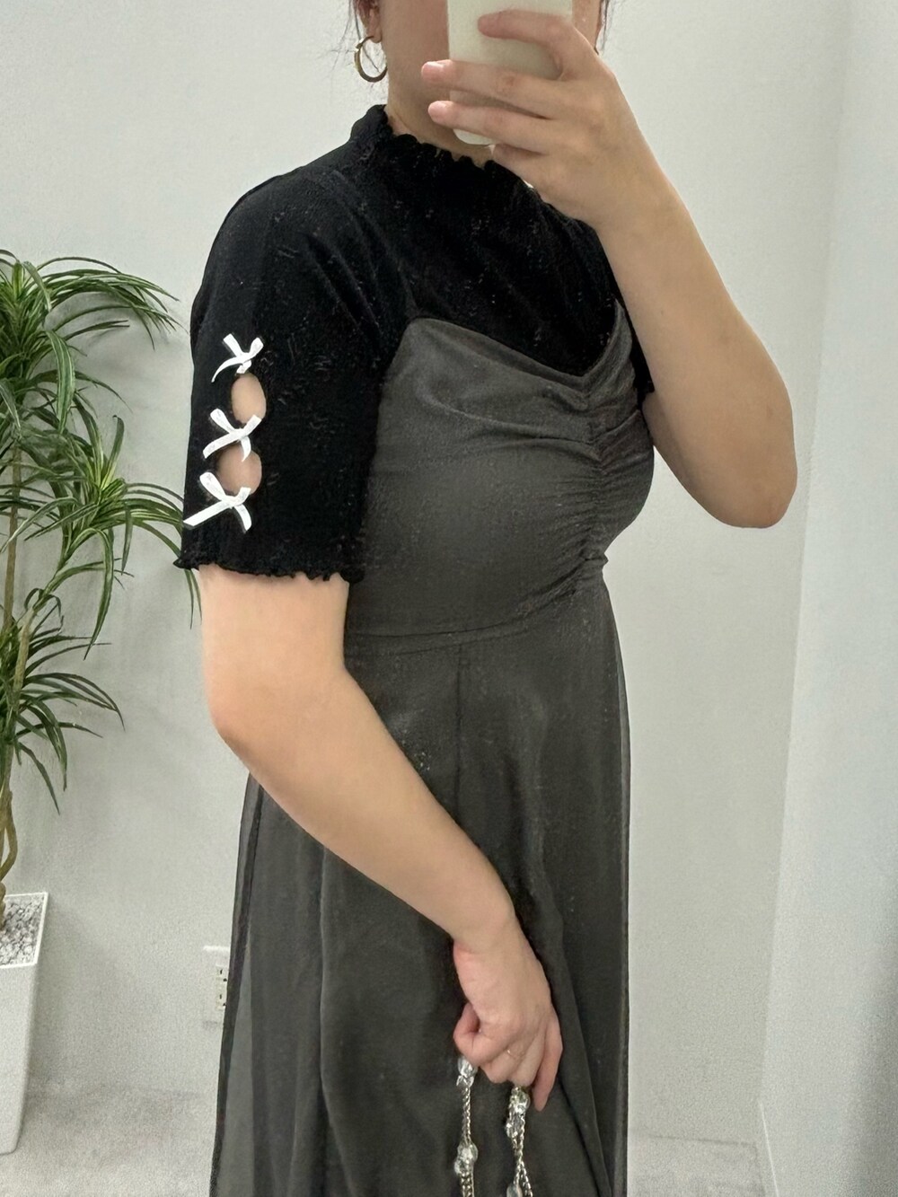 グレー系のワンピース/ドレス、ホワイト系のTシャツ/カットソー、ブラック系のショルダーバッグを着用したレディースの春コーディネートの2枚目の写真