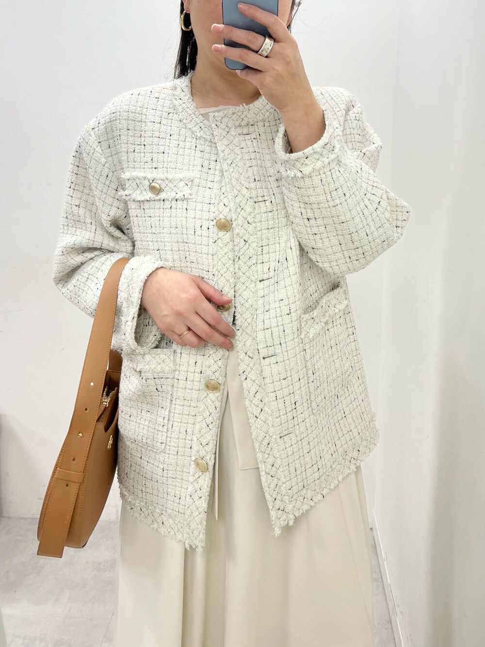 グレー系のワンピース、ホワイト系のブーツ、ブラウン系のショルダーバッグを着用したレディースの冬コーディネートの2枚目の写真