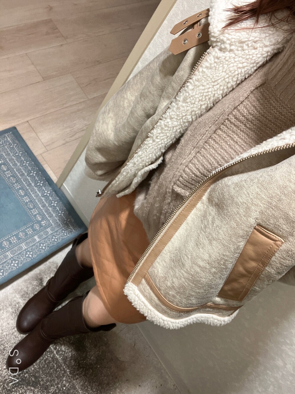 ブラウン系のブーツ、オレンジ系のスカートを着用したレディースの秋コーディネートの2枚目の写真