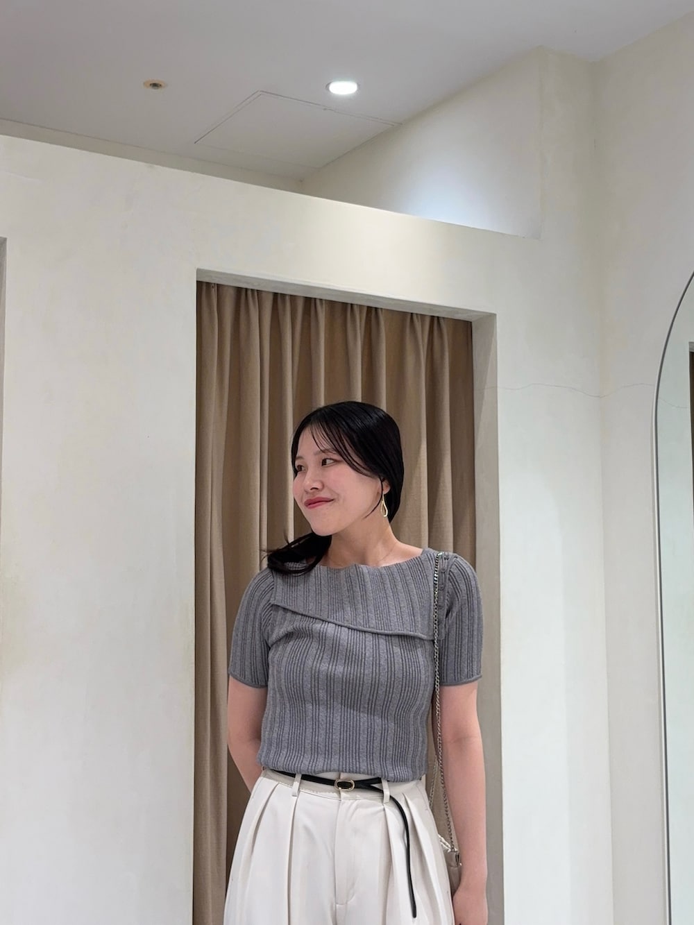 ホワイト系のその他パンツ、グレー系のニット/セーター、ホワイト系のショルダーバッグを着用したレディースの夏コーディネートの3枚目の写真