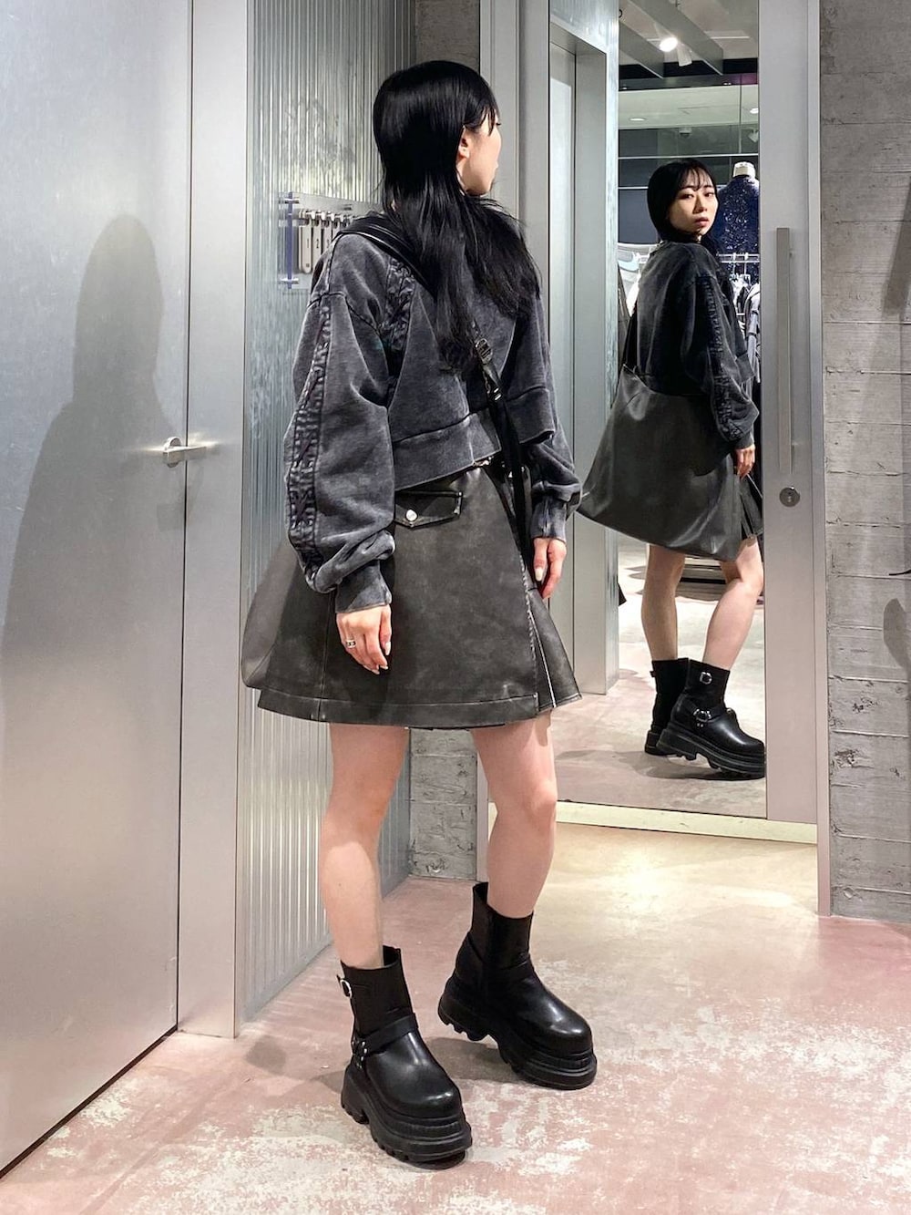 ブラック系のブーツ、グレー系のショルダーバッグ、ブラック系のスウェットを着用したレディースの冬コーディネートの4枚目の写真