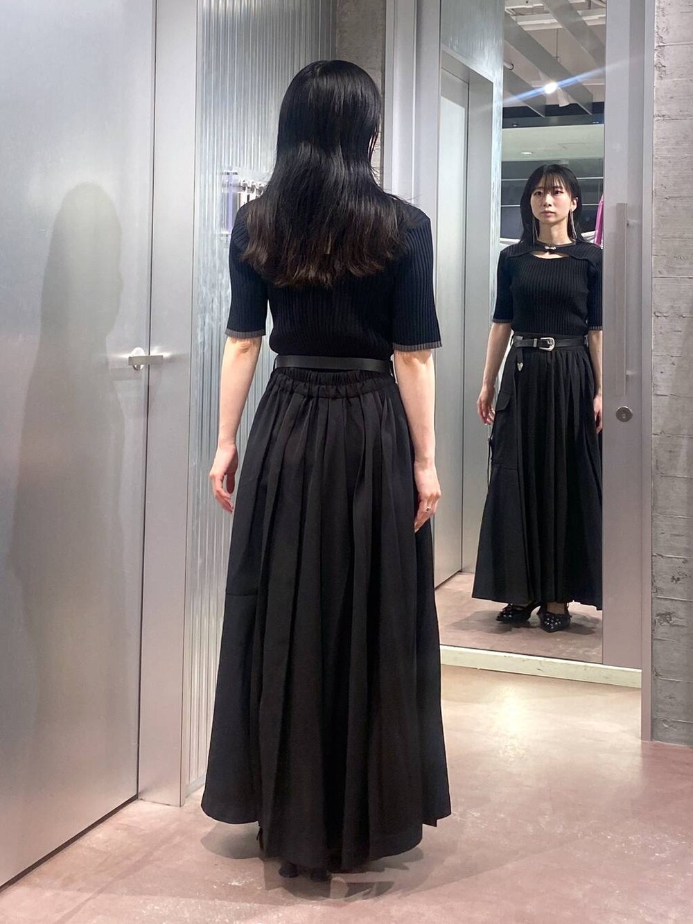 ブラック系のニット/セーター、ブラック系のパンプス、ブラック系のスカートを着用したレディースの夏コーディネートの3枚目の写真