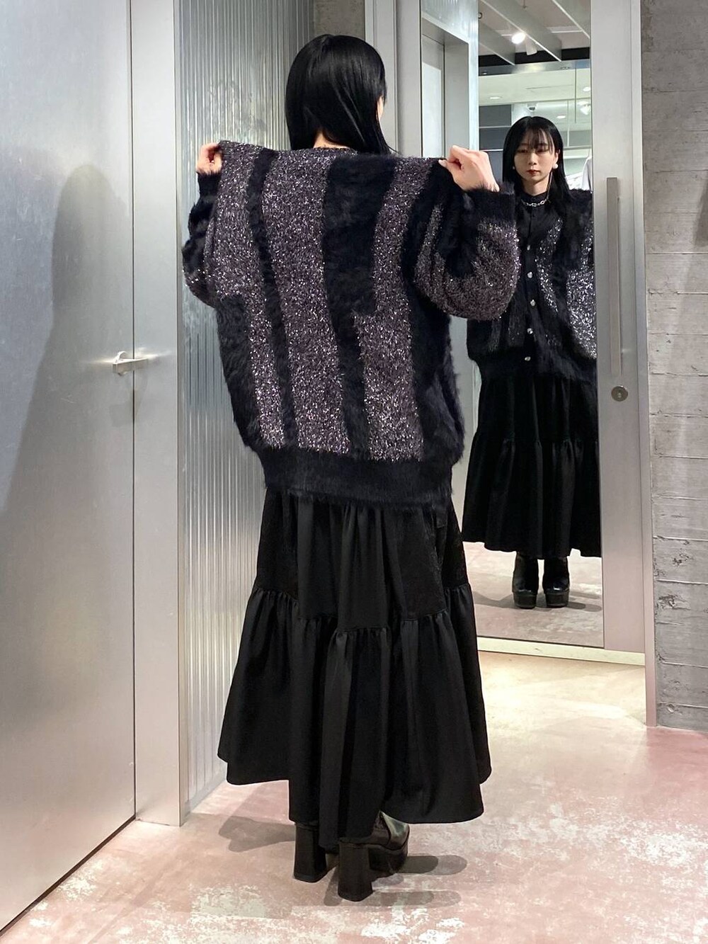 ブラック系のブーツ、ブラック系のワンピース、ブラック系のカーディガン/ボレロを着用したレディースの冬コーディネートの3枚目の写真