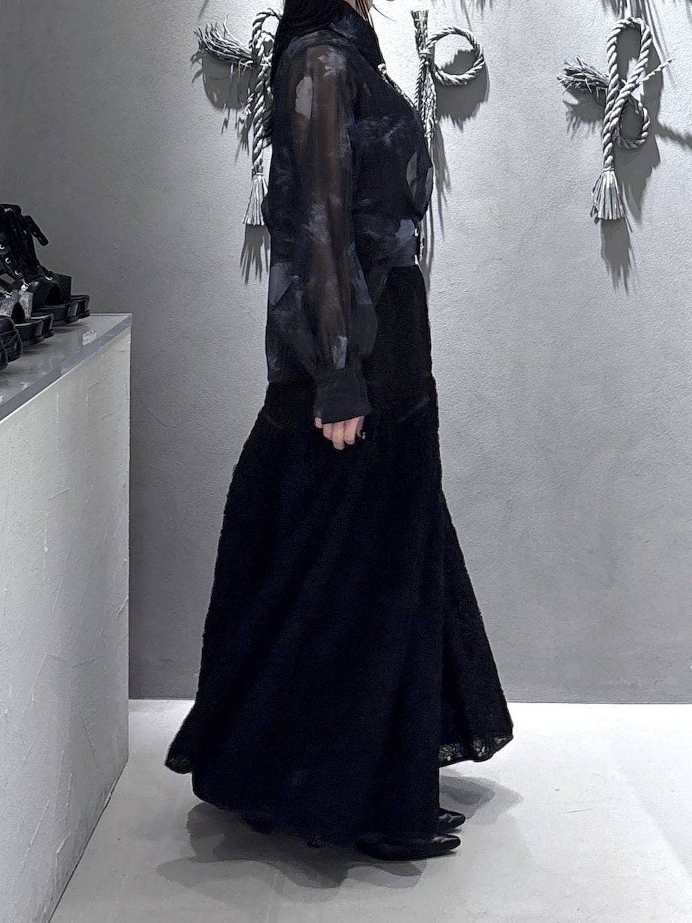 ブラック系のパンプス、ブラック系のタンクトップ、ブラック系のスカートを着用したレディースの春コーディネートの4枚目の写真