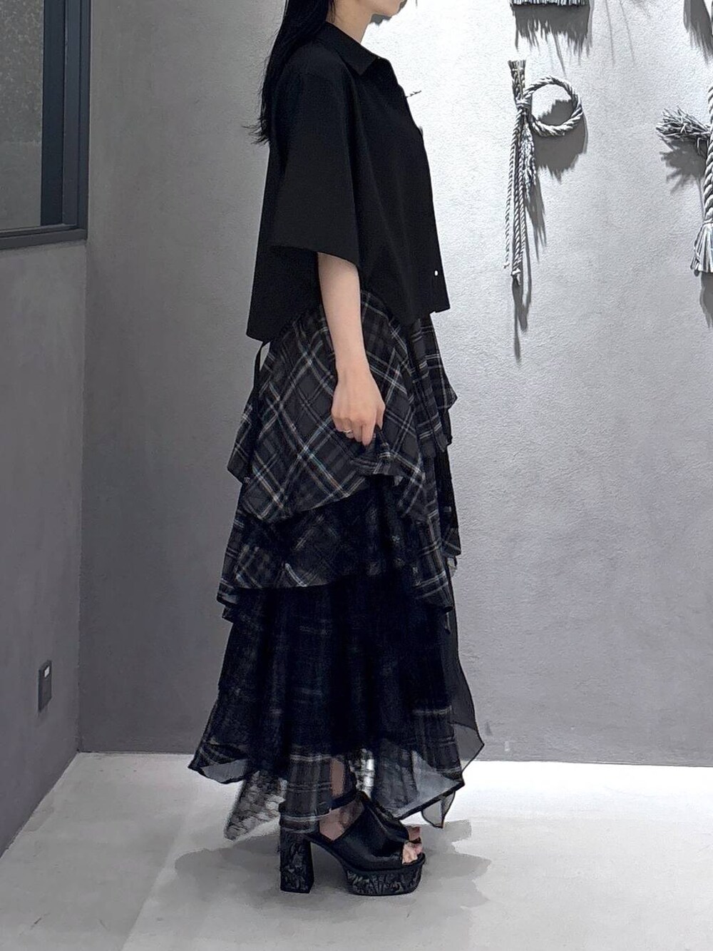 ブラック系のタンクトップ、グレー系のサンダル、ブラック系のスカートを着用したレディースの夏コーディネートの4枚目の写真