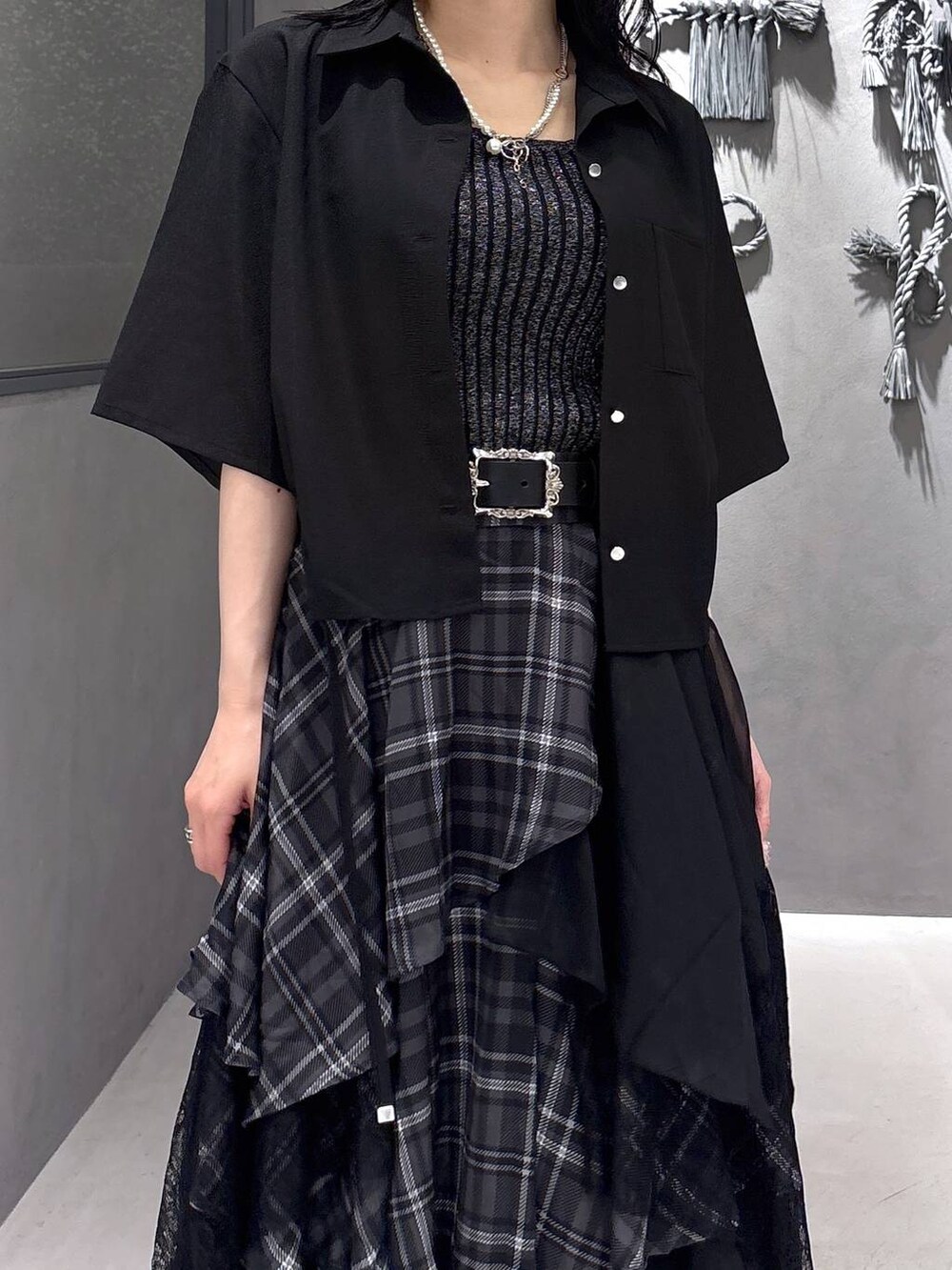 ブラック系のタンクトップ、グレー系のサンダル、ブラック系のスカートを着用したレディースの夏コーディネートの6枚目の写真