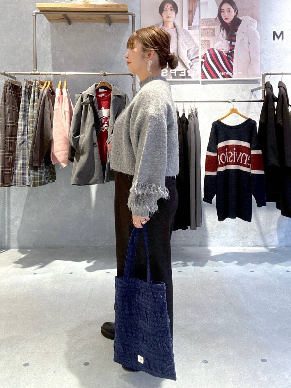 ブルー系のトートバッグ、ブラック系のその他パンツ、ブラック系のブーツを着用したレディースの冬コーディネートの4枚目の写真