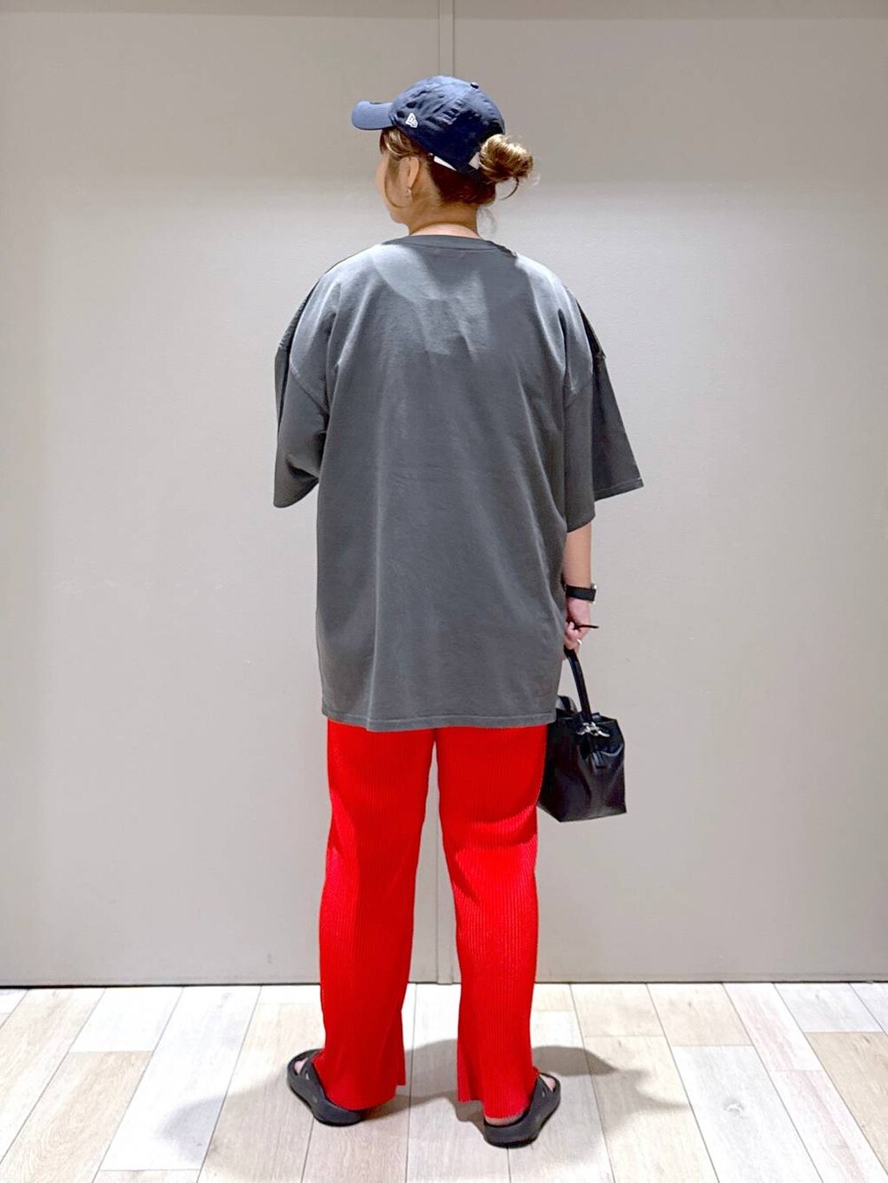 グレー系のTシャツ/カットソー、ブラック系のショルダーバッグ、ブラック系のサンダルを着用したレディースの春コーディネートの3枚目の写真