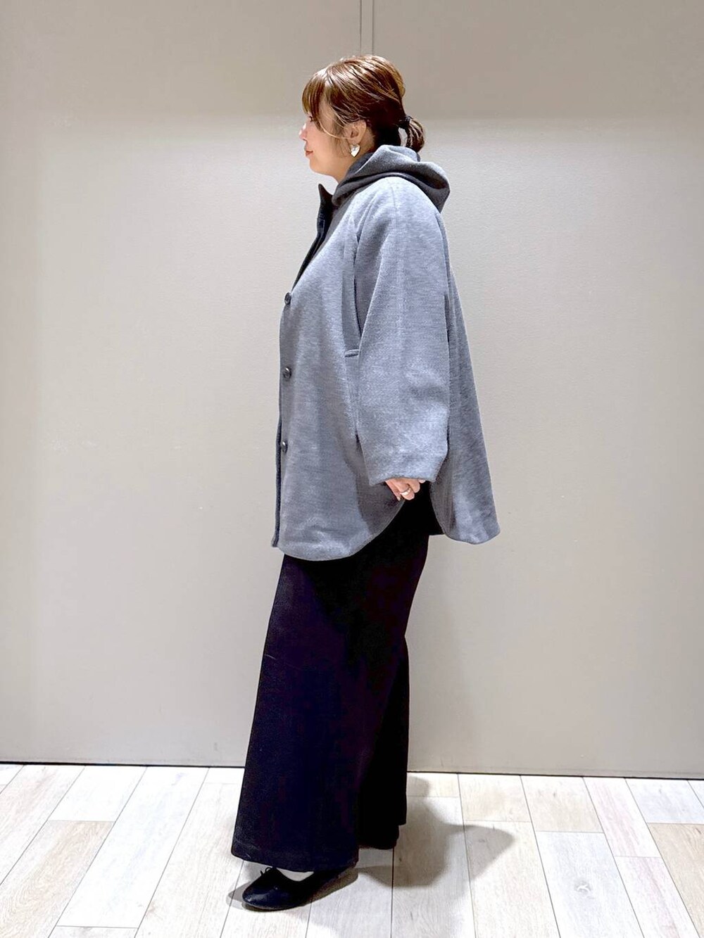 ブラック系のショルダーバッグ、グレー系のポンチョ、ブラック系のその他パンツを着用したレディースの冬コーディネートの4枚目の写真