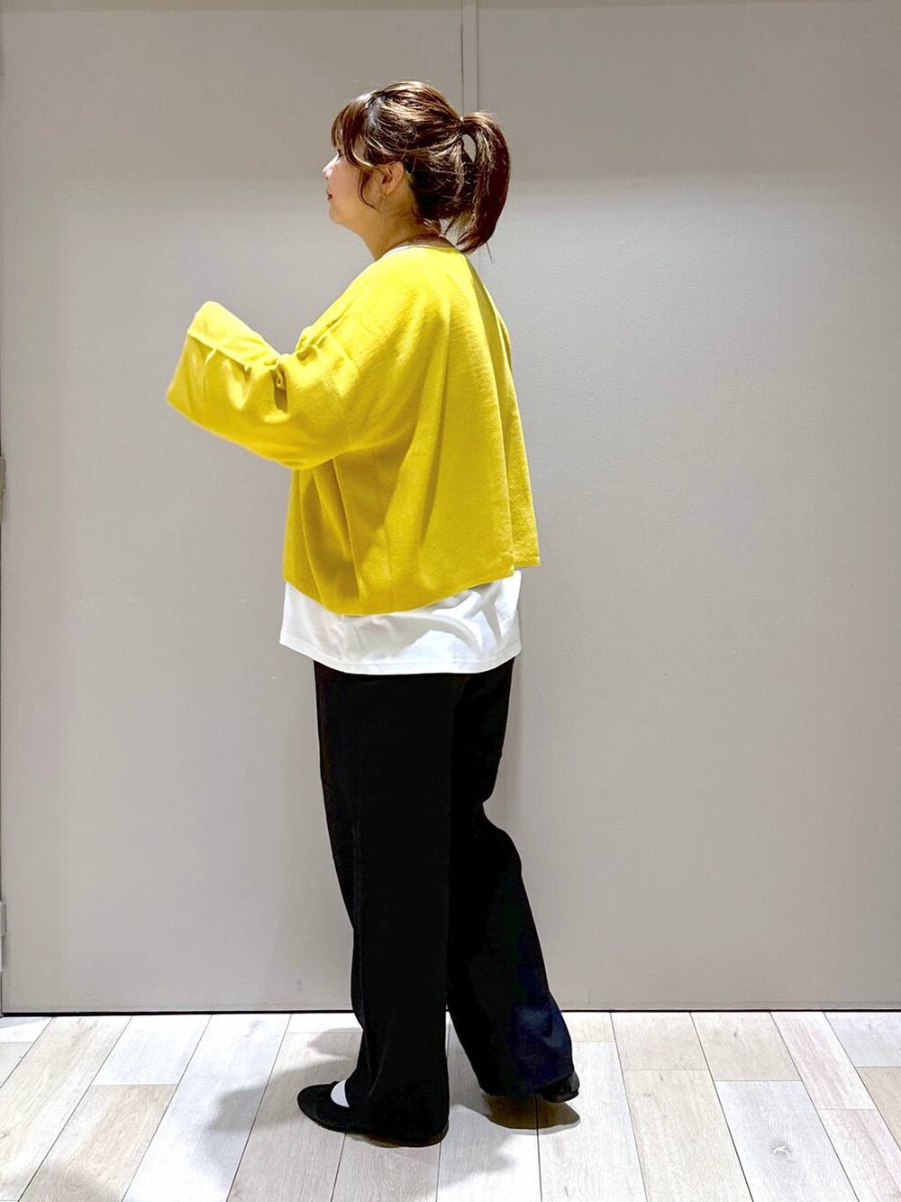 ブラック系のバレエシューズ、イエロー系のニット/セーター、ブラック系のボストンバッグを着用したレディースの秋コーディネートの4枚目の写真