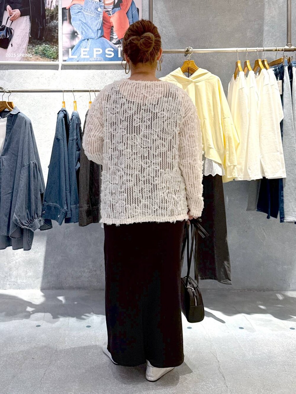 ホワイト系のTシャツ/カットソー、ブラック系のショルダーバッグ、シルバー系のパンプスを着用したレディースの春コーディネートの3枚目の写真