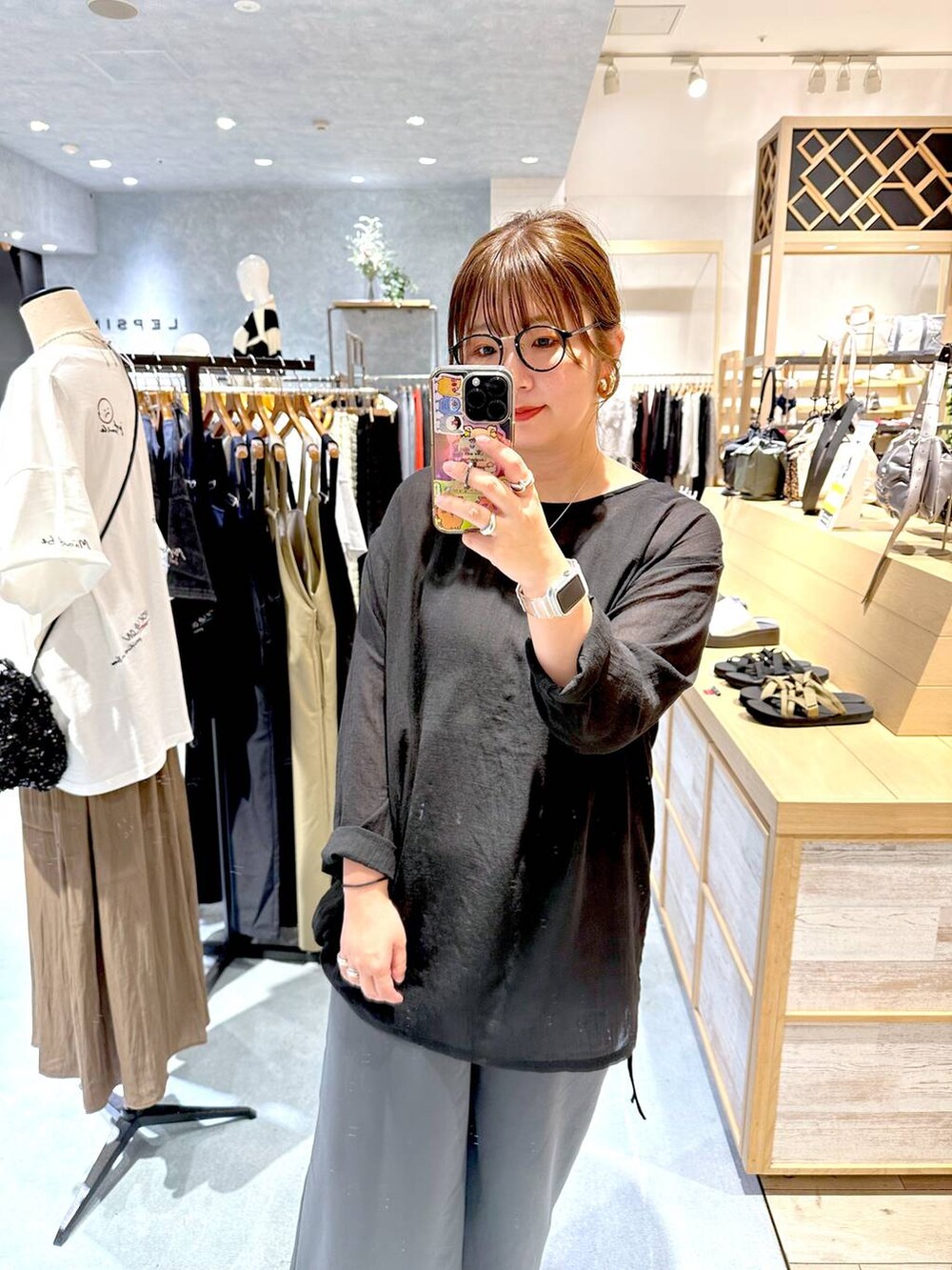 ブラック系のチュニック、グレー系のその他パンツを着用したレディースの秋コーディネートの3枚目の写真