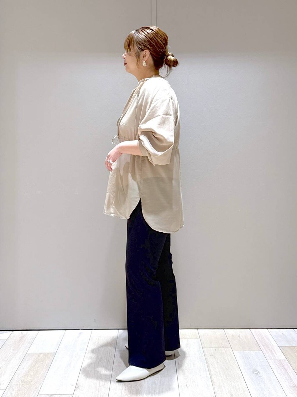 ブラック系のスラックス、ホワイト系のパンプス、ブラウン系のシャツ/ブラウスを着用したレディースの春コーディネートの4枚目の写真