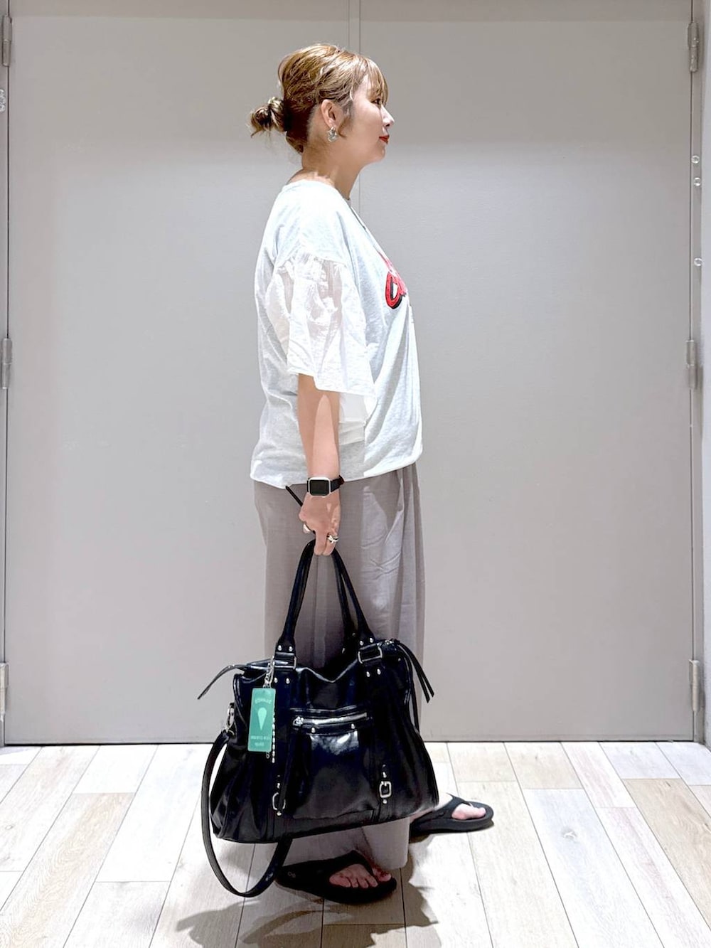 ブラック系のトートバッグ、ベージュ系のその他パンツ、ブラック系のサンダルを着用したレディースの春コーディネートの2枚目の写真
