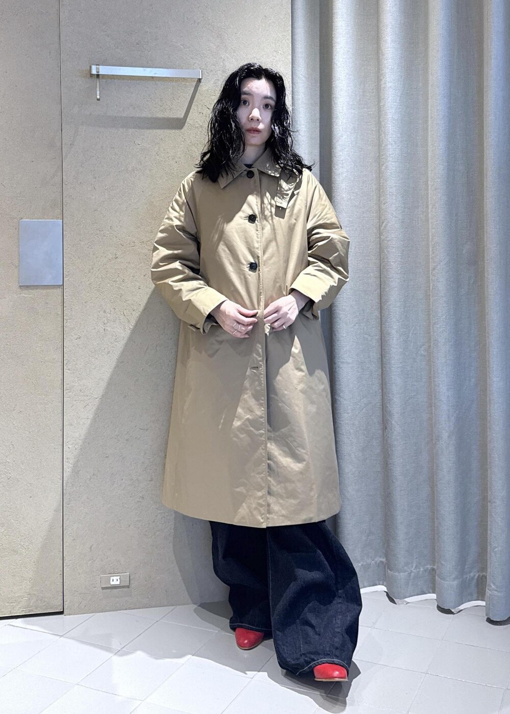 ベージュ系のダウンジャケット/コート、レッド系のパンプス、ブルー系のデニムパンツを着用したレディースの秋コーディネートの7枚目の写真