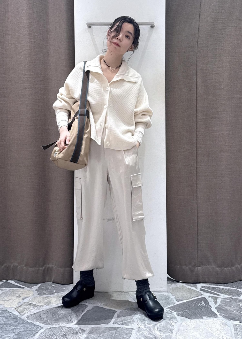 ホワイト系のカーディガン/ボレロ、ホワイト系のカーゴパンツ、ベージュ系のトートバッグを着用したレディースの冬コーディネートの3枚目の写真