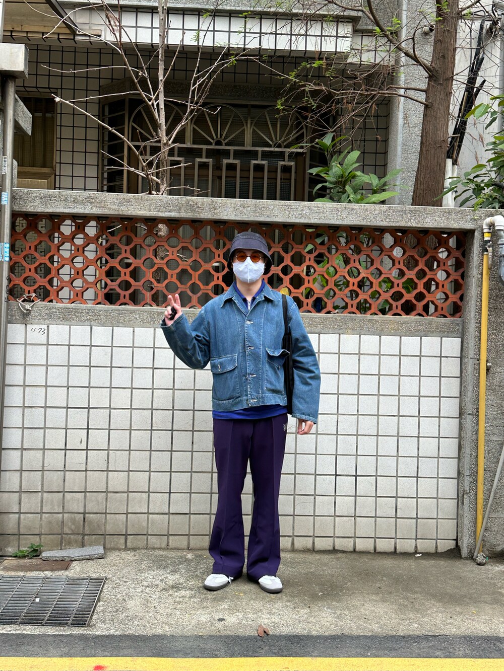 ブルー系のデニムジャケット、パープル系のその他パンツ、ホワイト系のシューズを着用したメンズの春コーディネートの2枚目の写真