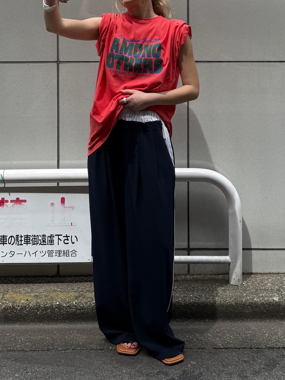 オレンジ系のTシャツ/カットソー、ブルー系のその他パンツ、その他のサンダルを着用したレディースの春コーディネートの3枚目の写真