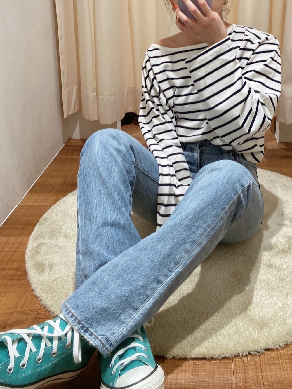 ブルー系のTシャツ/カットソー、ブルー系のデニムパンツ、グリーン系のスニーカーを着用したレディースの冬コーディネートの2枚目の写真
