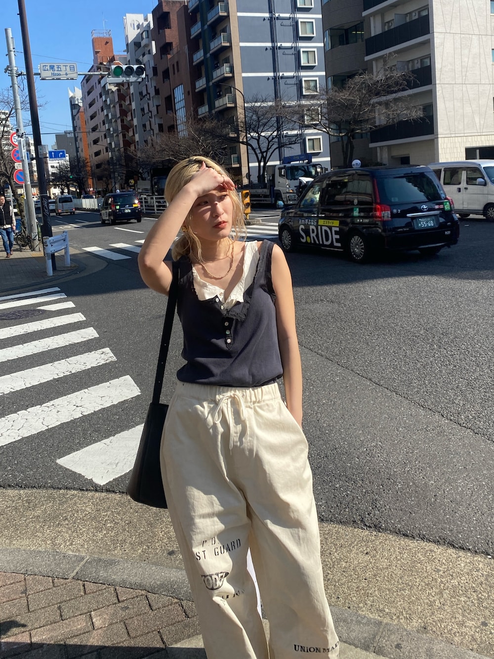 グレー系のタンクトップ、ホワイト系のタンクトップ、ホワイト系のその他パンツを着用したレディースの春コーディネートの3枚目の写真