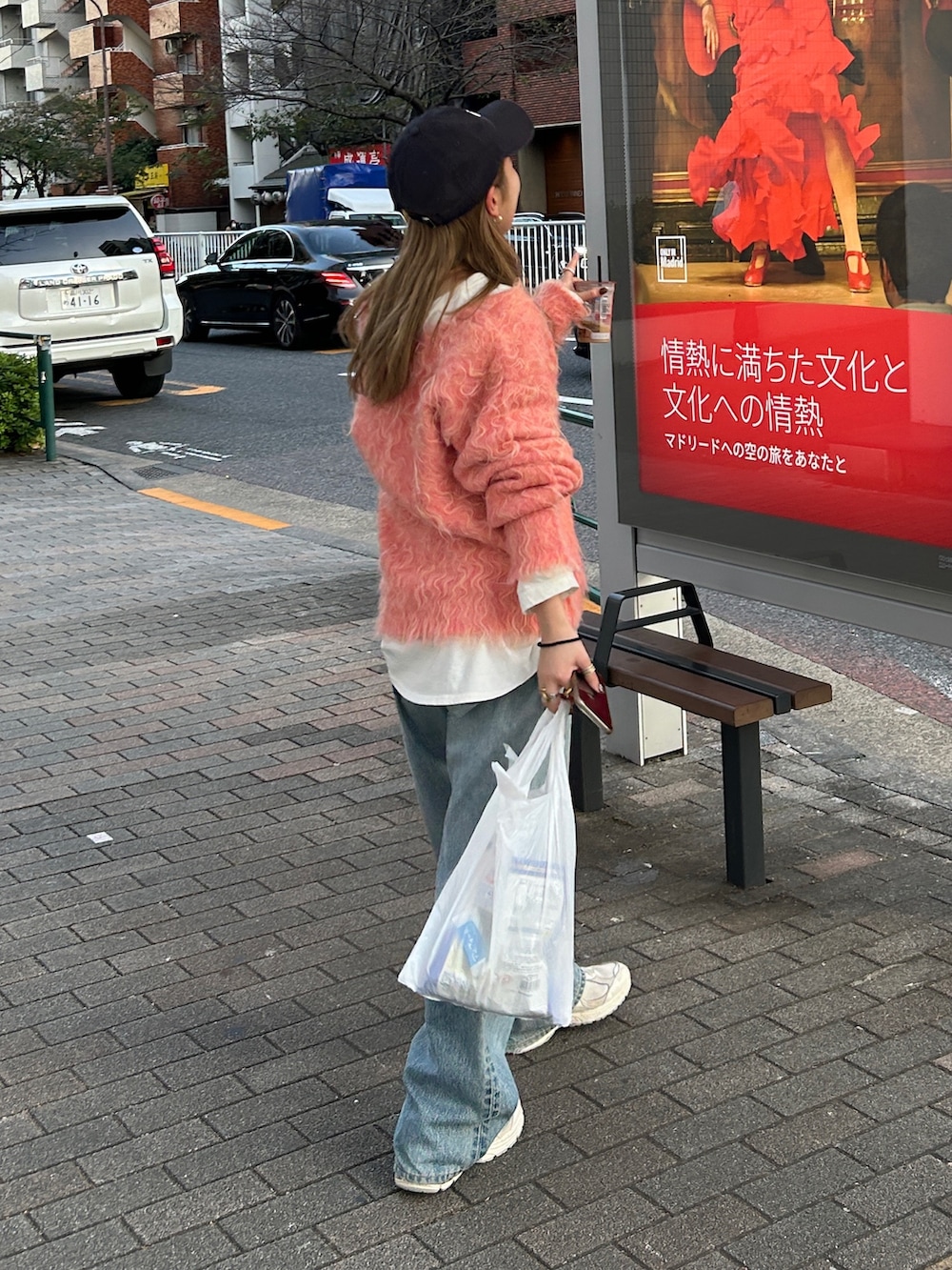 ピンク系のニット/セーター、ホワイト系のTシャツ/カットソー、ブルー系のデニムパンツを着用したレディースの冬コーディネートの3枚目の写真