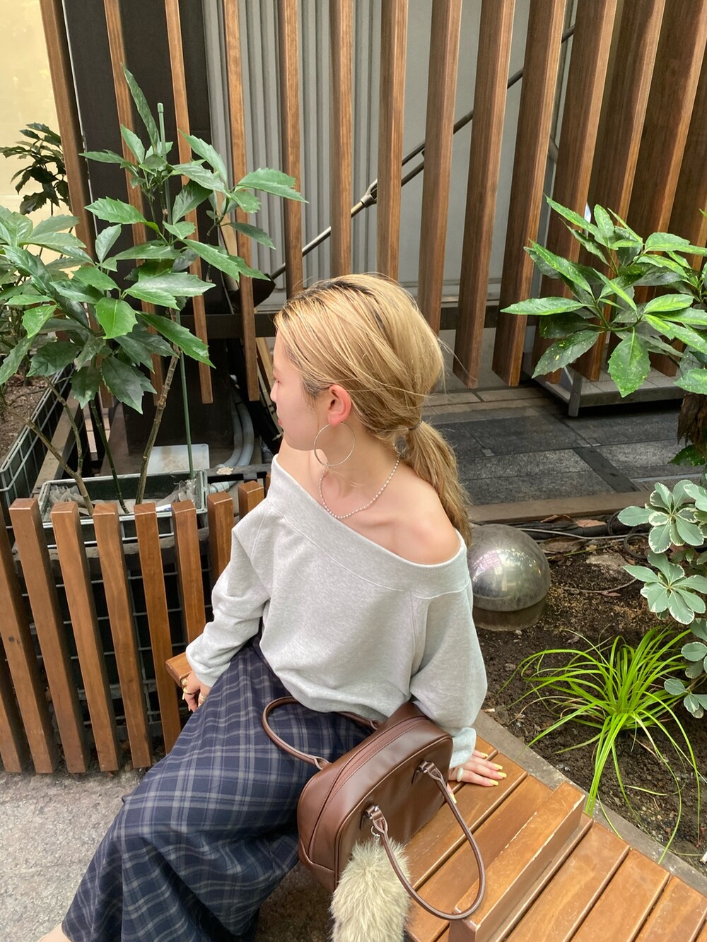 グレー系のスウェット、ブルー系のスカート、ゴールド系のバレエシューズを着用したレディースの夏コーディネートの5枚目の写真