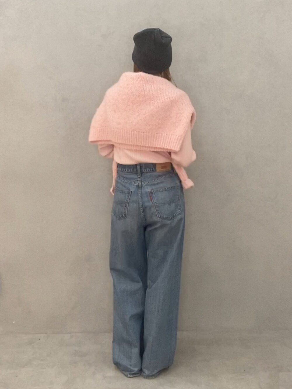 ピンク系のニット/セーター、ピンク系のニット/セーター、ブルー系のデニムパンツを着用したレディースの冬コーディネートの3枚目の写真