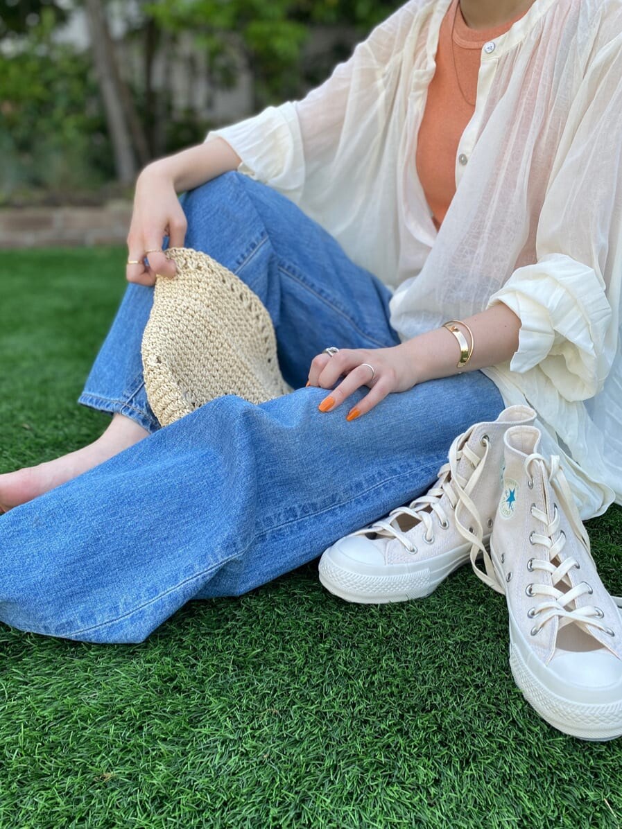 グリーン系のサンダル、ブルー系のデニムパンツ、ホワイト系のスニーカーを着用したレディースの夏コーディネートの8枚目の写真