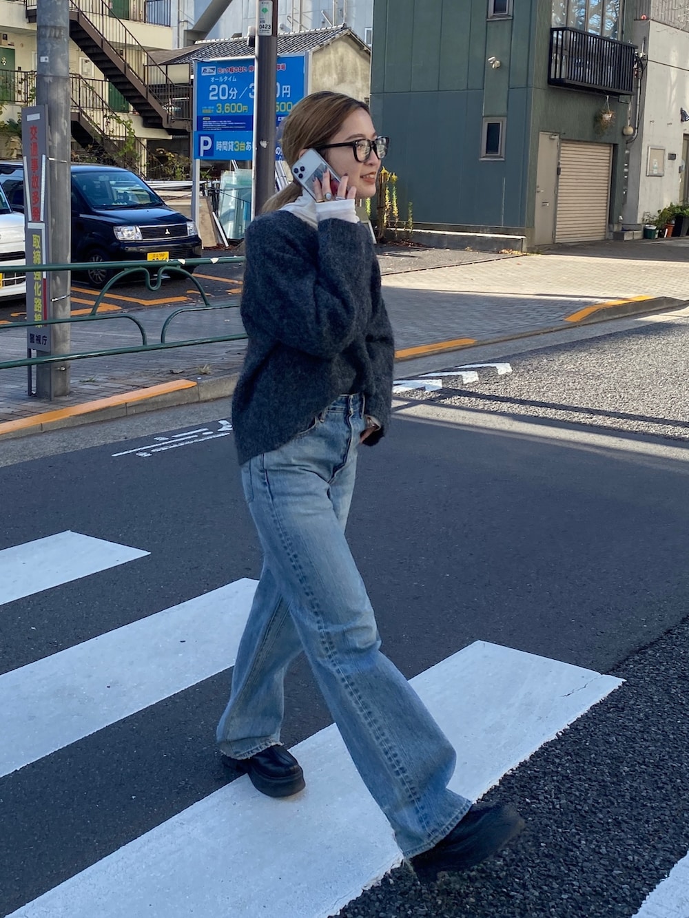 グレー系のニット/セーター、ブルー系のデニムパンツ、ブラック系のブーツを着用したレディースの冬コーディネートの3枚目の写真