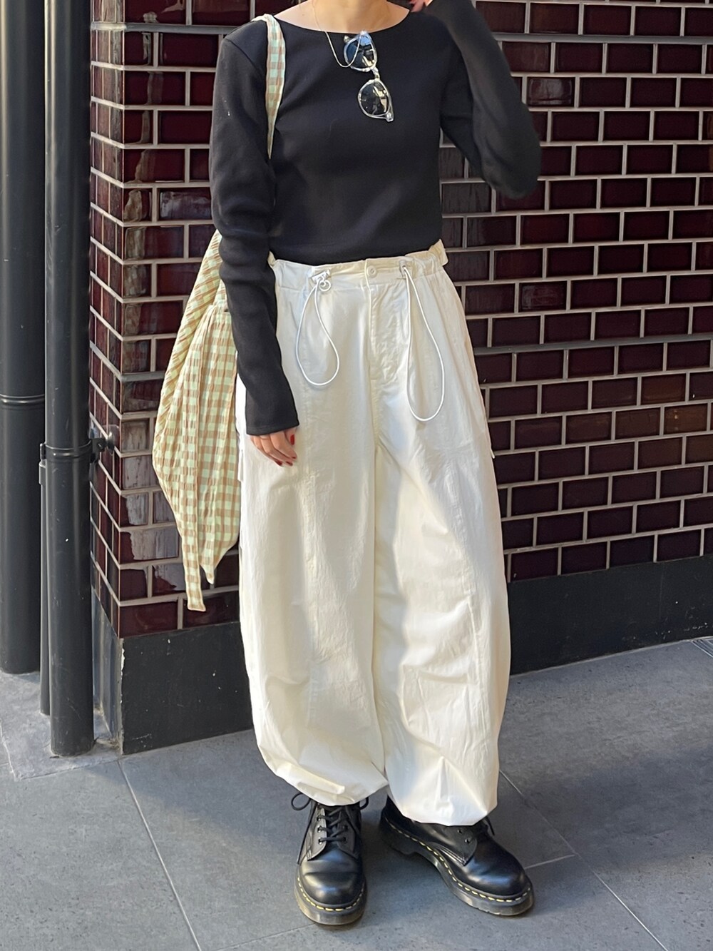 ブラック系のTシャツ/カットソー、ホワイト系のカーゴパンツ、グリーン系のショルダーバッグを着用したレディースの春コーディネートの6枚目の写真