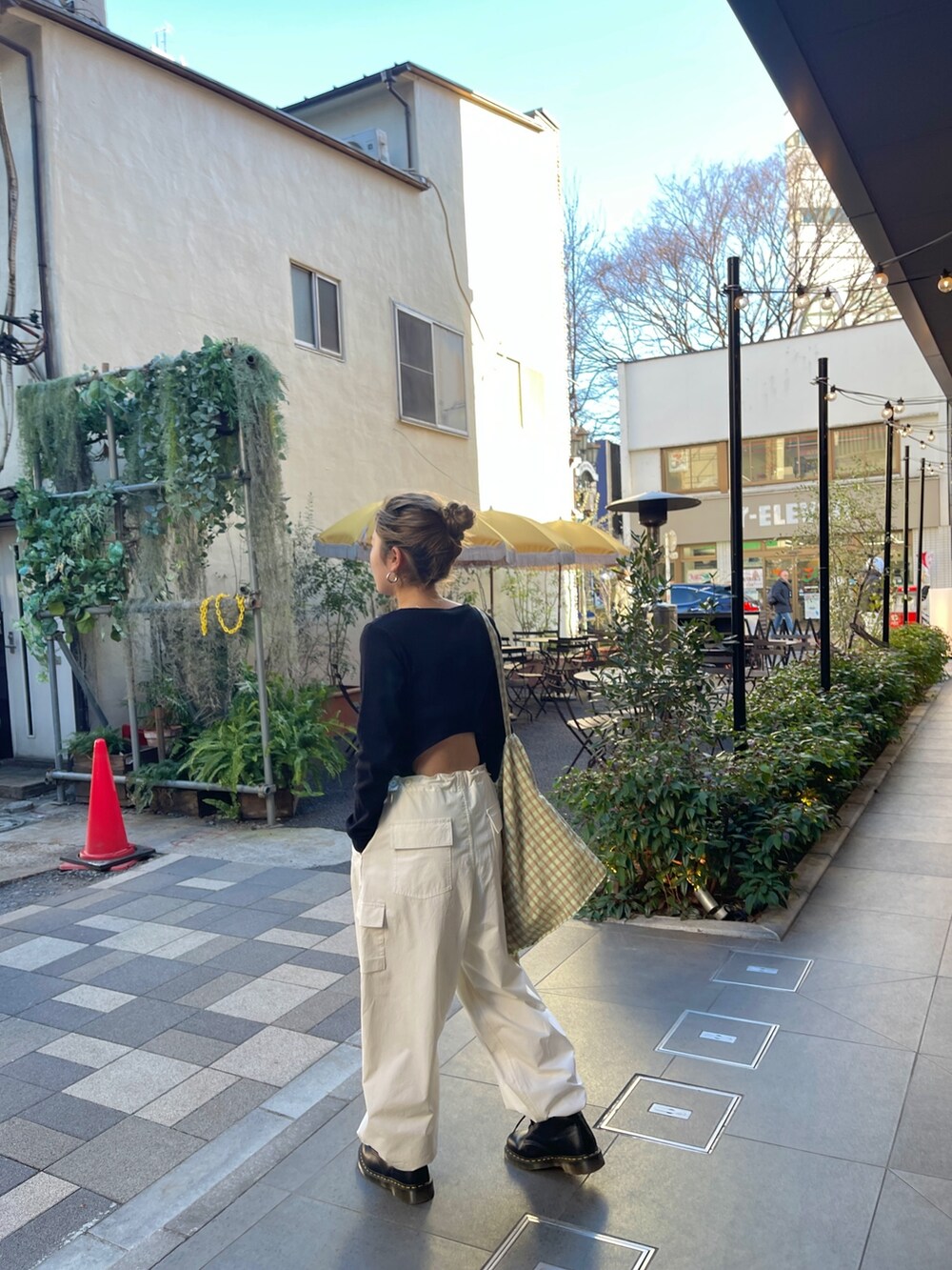 ブラック系のTシャツ/カットソー、ホワイト系のカーゴパンツ、グリーン系のショルダーバッグを着用したレディースの春コーディネートの3枚目の写真