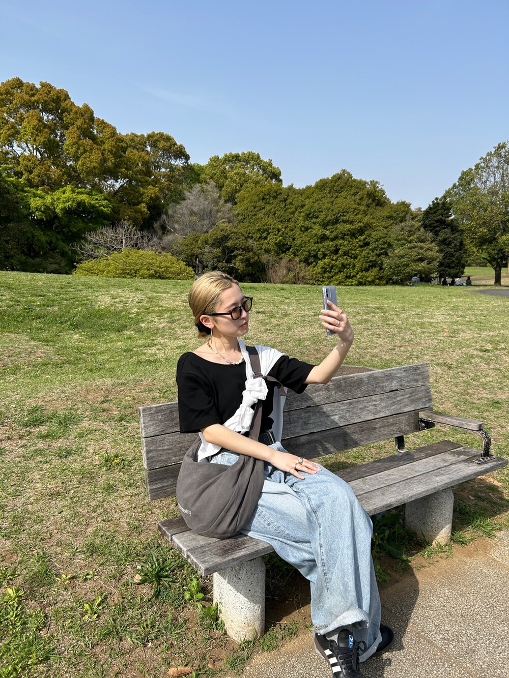 ブラック系のTシャツ/カットソー、ホワイト系のシャツ/ブラウス、グレー系のハンドバッグを着用したレディースの春コーディネートの5枚目の写真