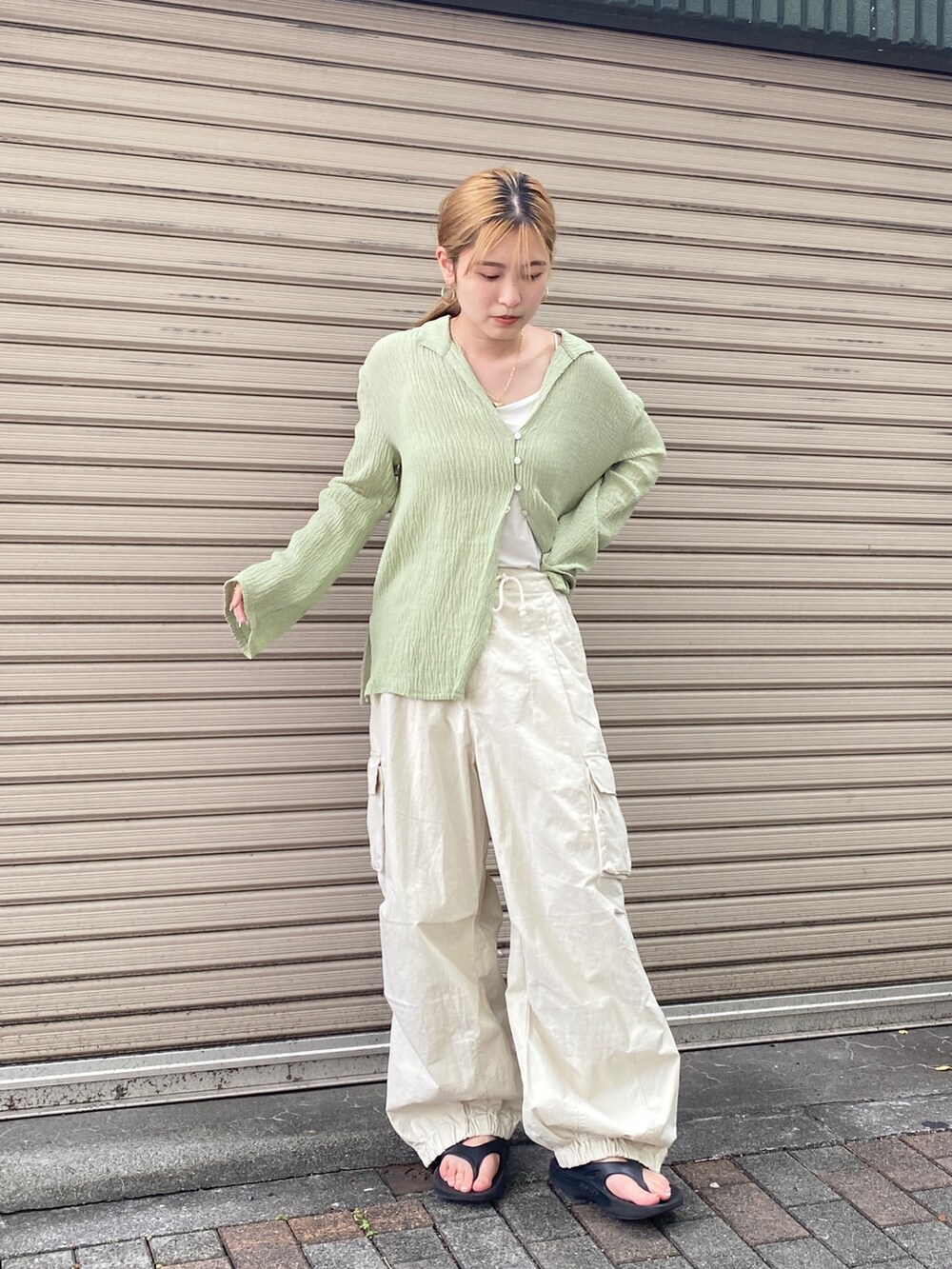 グリーン系のシャツ/ブラウス、ホワイト系のカーゴパンツを着用したレディースの夏コーディネートの5枚目の写真