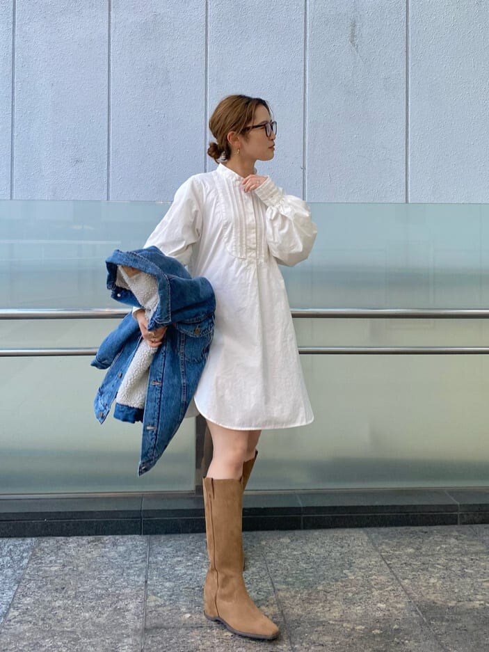 ベージュ系のブーツ、ブルー系のデニムジャケット、ホワイト系のシャツ/ブラウスを着用したレディースの冬コーディネートの2枚目の写真