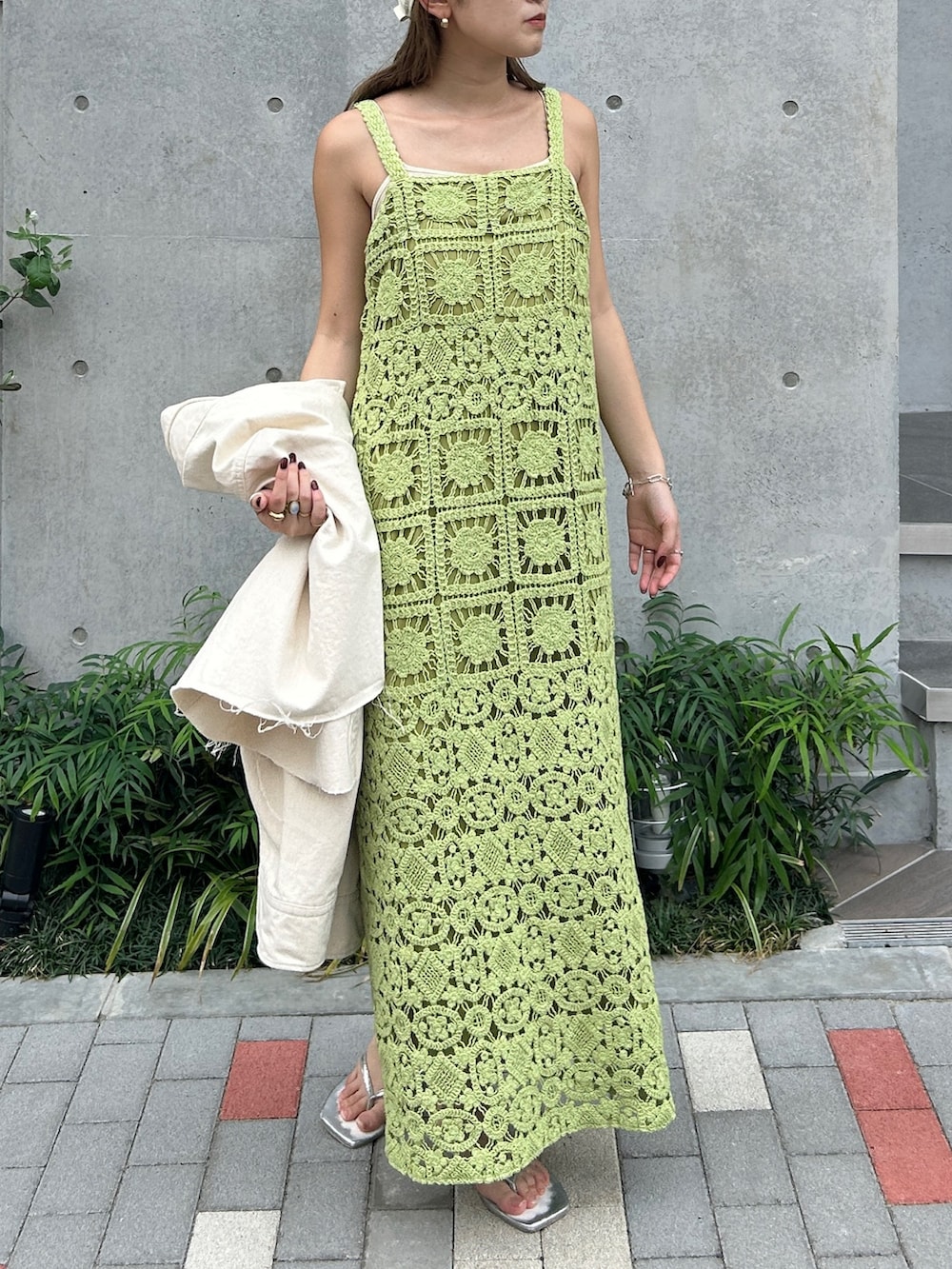 グリーン系のワンピース、ホワイト系のシャツ/ブラウス、ホワイト系のキャップを着用したレディースの春コーディネートの4枚目の写真