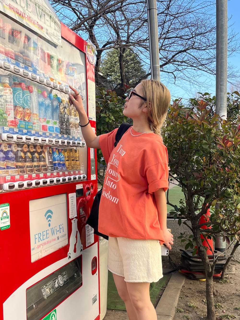 オレンジ系のTシャツ/カットソー、ホワイト系のその他パンツ、ブラック系のメガネを着用したレディースの夏コーディネートの2枚目の写真