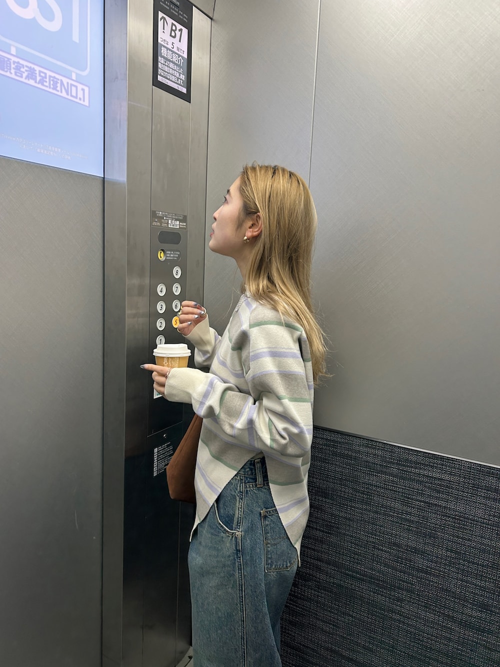 ホワイト系のニット/セーター、ブルー系のデニムパンツを着用したレディースの春コーディネートの5枚目の写真