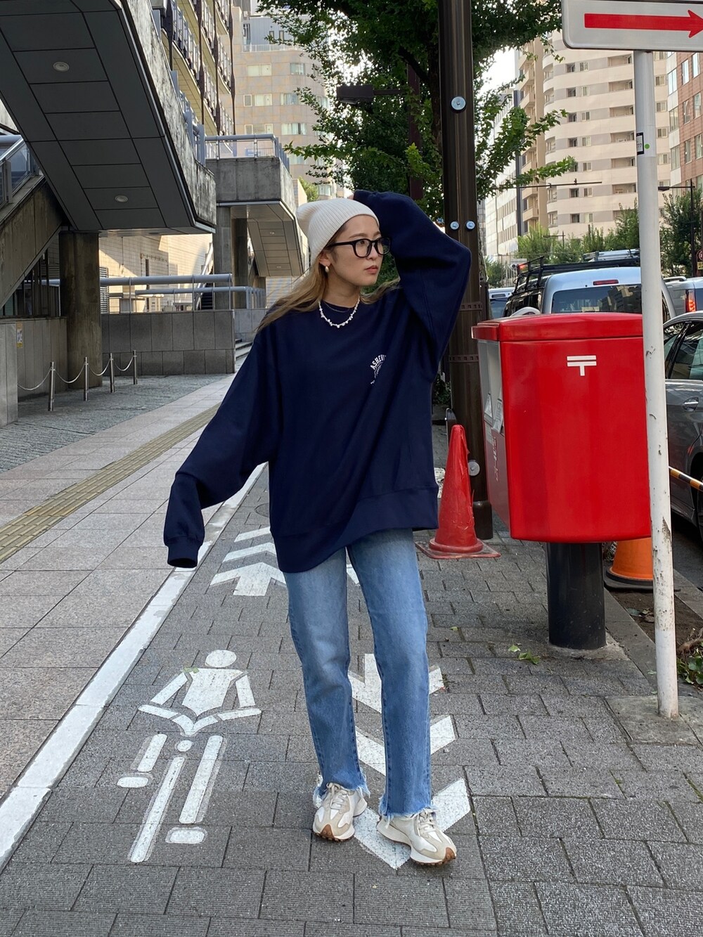 ブルー系のスウェット、ブルー系のデニムパンツ、ホワイト系のニットキャップ/ビーニーを着用したレディースの秋コーディネートの4枚目の写真