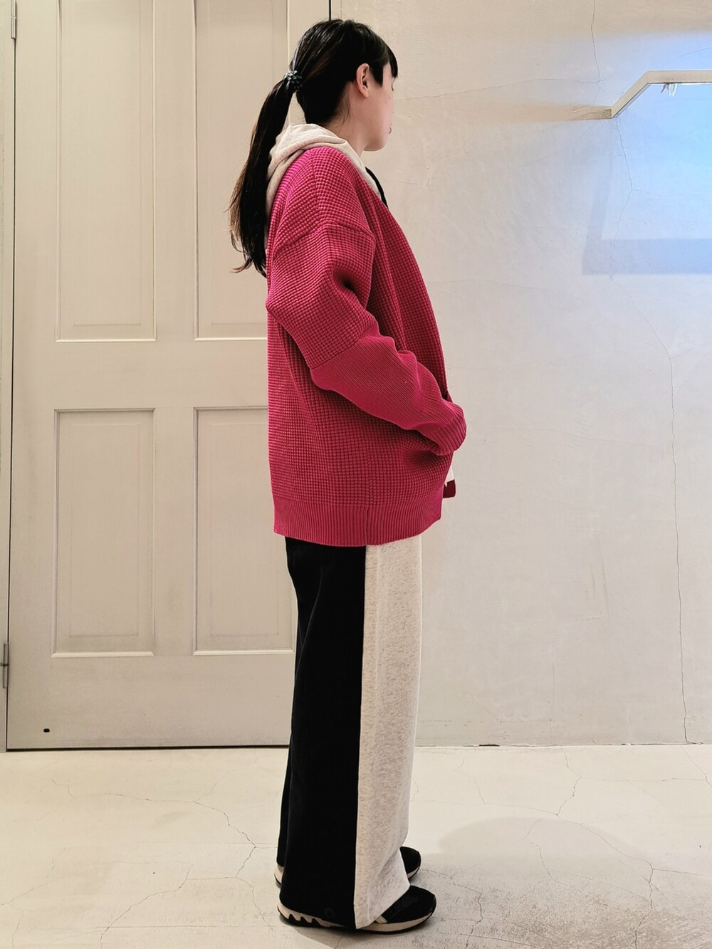 ピンク系のカーディガン/ボレロ、グレー系のその他パンツ、グレー系のパーカーを着用したレディースの冬コーディネートの4枚目の写真