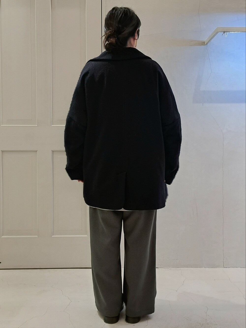 ブルー系のピーコート、グレー系のスウェット、グレー系のスラックスを着用したレディースの秋コーディネートの3枚目の写真