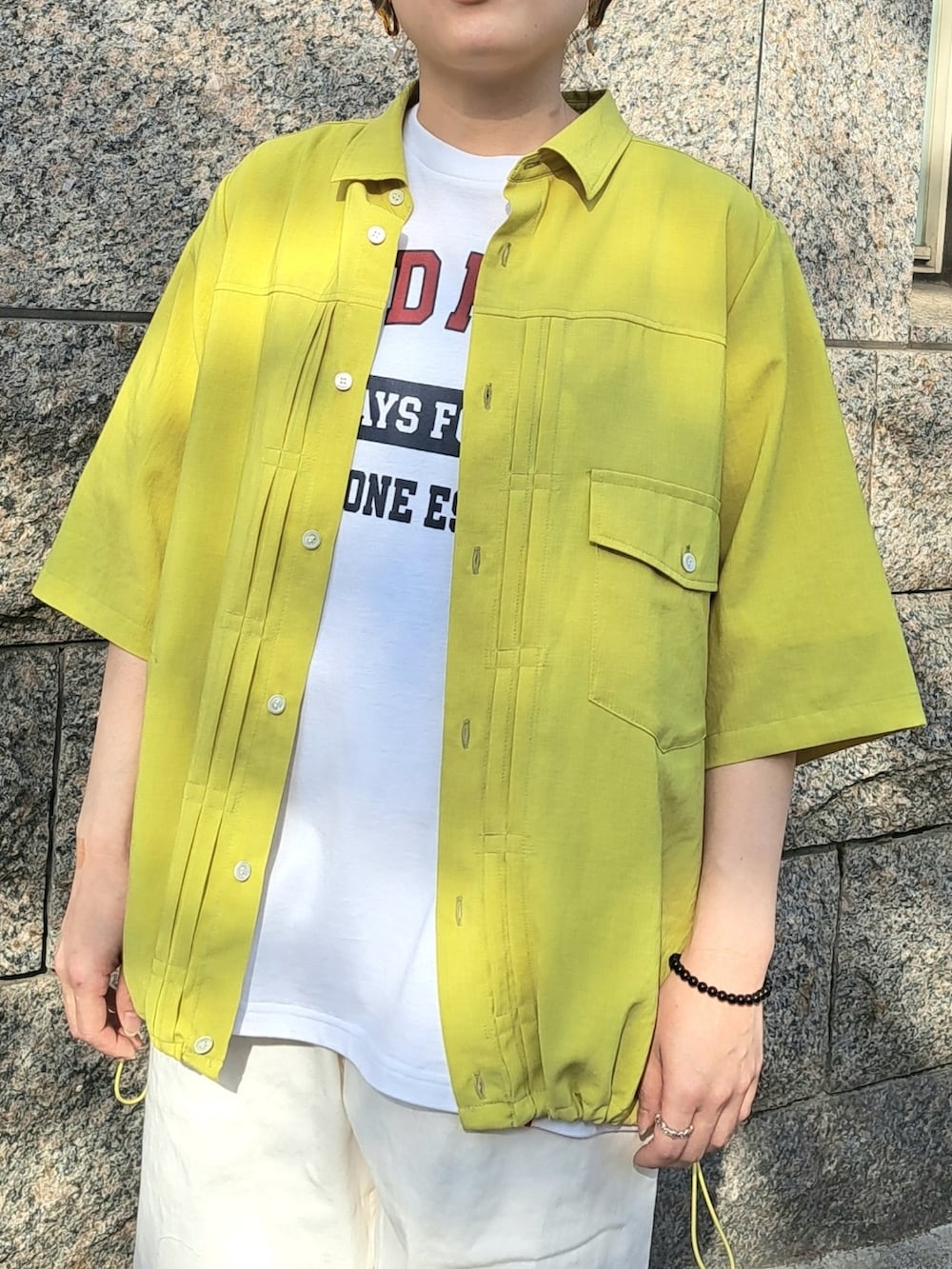 イエロー系のシャツ/ブラウス、ホワイト系のTシャツ/カットソー、ホワイト系のデニムパンツを着用したレディースの春コーディネートの5枚目の写真