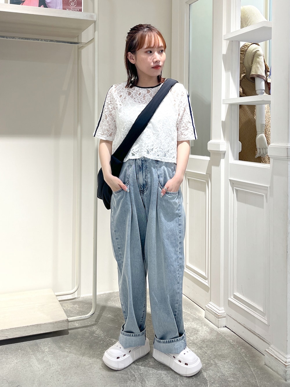 ブルー系のデニムパンツ、ホワイト系のTシャツ/カットソー、ブラック系のショルダーバッグを着用したレディースの夏コーディネートの2枚目の写真