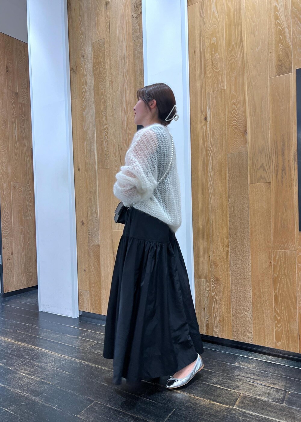 シルバー系のバレエシューズ、ホワイト系のニット/セーター、ブラック系のスカートを着用したレディースの夏コーディネートの3枚目の写真