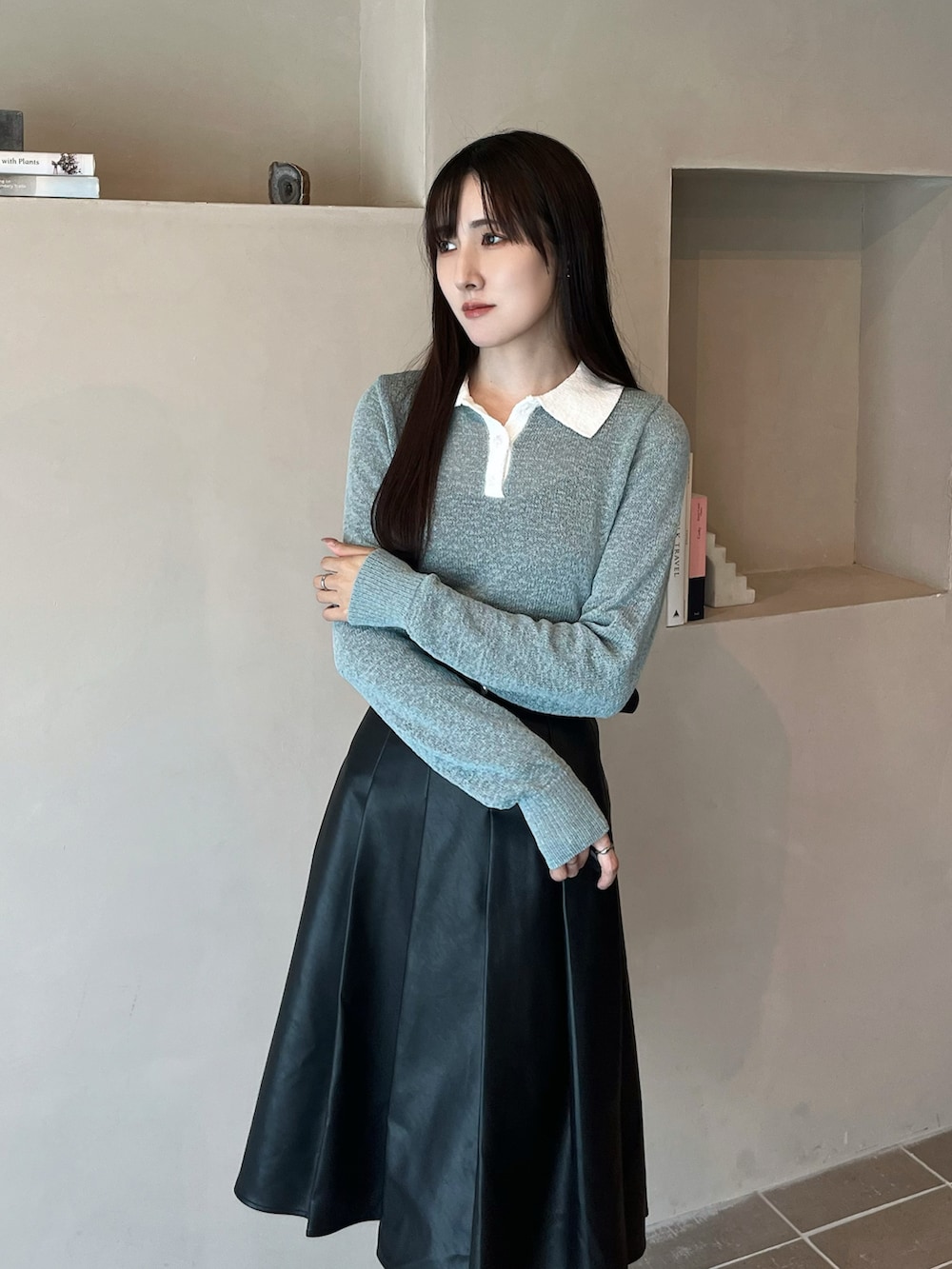 ブラック系のブーツ、ブラック系のスカート、ブルー系のニット/セーターを着用したレディースの秋コーディネートの4枚目の写真