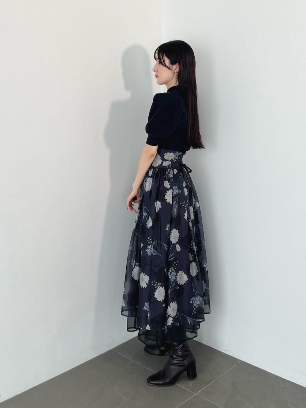 ブラウン系のブーツ、ブルー系のニット/セーター、グレー系のスカートを着用したレディースの夏コーディネートの3枚目の写真