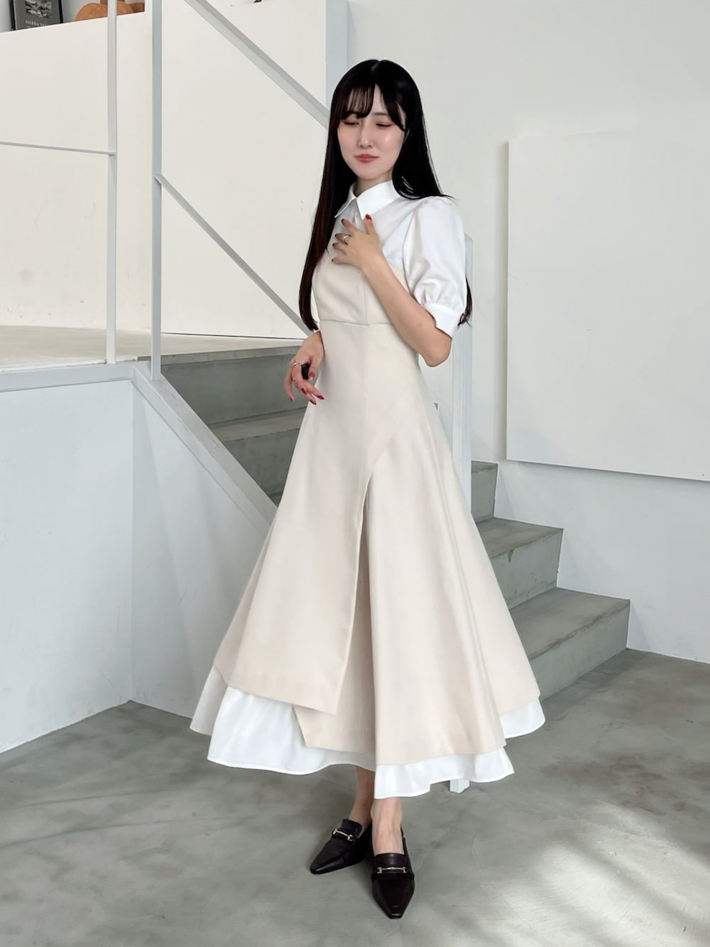 ブラウン系のパンプス、ベージュ系のワンピースを着用したレディースの春コーディネートの2枚目の写真