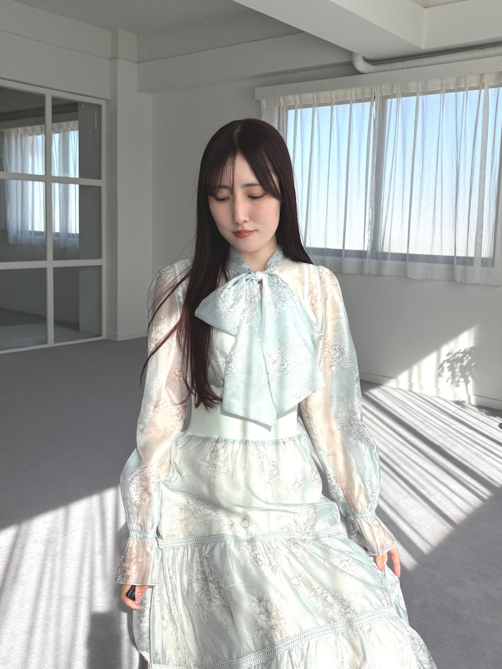 ブラック系のパンプス、グリーン系のワンピースを着用したレディースの春コーディネートの5枚目の写真